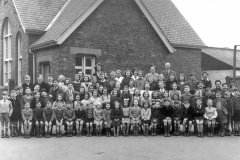 This picture  is of the whole school in 1952. It was taken in the playground outside the infants' classroom with the canteen in the background.
It shows, from left to right 

Back row: Mrs White (teacher), Mrs Leadill (teacher), Miss Smith (canteen), Mrs Lilley (canteen), Mrs Ward (office), Mr Bramley (headmaster).

Fourth row: Colin Wilburn, Alan Malcolmson, Roy Chapman, Eunice Flint, Dawn Dove, Betty Brown, Pat Crewe, Alwyn Wraith, Doreen Crewe, Joan Gilbert, Rosemary Bradshaw, Francis Kirk, June Gilbert, Doreen Wilson, Pat Lilley, Audrey Binnington, Robert Jackson, Brian Laverack.

Third row: Dave Hoggard, Irvin Robinson, Marjorie Lilley, Evelyn Brown, Mary Hall, Janice Flint, Marie Brown, Sheila Laverack, June Brown, Berenice Greenwood, John Gaskin, Alec Wraith, Peter Kirk, Norman Kay, John Holt.

Second row: Michael Timm, Richard Leadill, Jack Young, Terence Thirkill, Tony Kay, Barry Malcolmson, Roy Metcalfe, Karen Greenwood, Christine Chapman, Mary Holmes, Marjorie Brown, Barbara Robinson, Joan Kirk, Phylis Holt, Enid Hoggard, Josie Lowther, Denise Young, Anne Lilley, Audrey Robinson, Mary Hardcastle, Leslie Binnington, David Watkinson, Malcolm Hoggard, George Gilbert, John Brown.

Front row: Alan Taverner, Brian Kirk, Michael Gaskin, Peter Gaskin, Geoff Smith, David Thorley, Terence Clark, Hilary Crabtree, Jennifer Binnington, Rita Malcolmson, Jennifer Nurse, Anne Jackson, Jackie Robinson, Trevor Laverack, Colin Myers, Eric Brown, ?, ?, Keith Wilson.